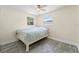 Bedroom with a neutral palette, ceiling fan, and large window, creating a bright and airy atmosphere at 11829 104Th St, Largo, FL 33773