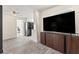 Inviting living room featuring a TV, modern flooring, and an open view into the kitchen at 11829 104Th St, Largo, FL 33773