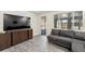 Comfortable living room with gray sectional sofa, TV, and access to a screened-in porch at 11829 104Th St, Largo, FL 33773