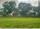 Spacious backyard with lush green lawn and privacy fence at 1286 Mission Hills Blvd, Clearwater, FL 33759