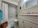 Bright bathroom featuring a white vanity and tiled shower at 1286 Mission Hills Blvd, Clearwater, FL 33759