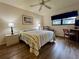 Comfortable bedroom with wood floors, large window, and work area at 1286 Mission Hills Blvd, Clearwater, FL 33759