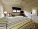 Well-lit bedroom with dresser, recliner, and expansive window views at 1286 Mission Hills Blvd, Clearwater, FL 33759