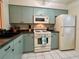 Cozy kitchen with stainless appliances, including a microwave and refrigerator at 1286 Mission Hills Blvd, Clearwater, FL 33759