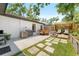 Charming backyard featuring an outdoor seating area, fire pit, and lush greenery at 1313 W Carissa Ct, Tampa, FL 33604