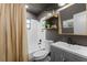 Modern bathroom featuring a shower-tub combo, stylish vanity, and decorative shelving at 1313 W Carissa Ct, Tampa, FL 33604