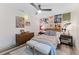 Inviting bedroom featuring an eclectic wall decor, overhead fan, and wood-look flooring at 1313 W Carissa Ct, Tampa, FL 33604