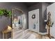 Stylish entryway featuring a large decorative mirror, a coat rack, and a view of the kitchen at 1313 W Carissa Ct, Tampa, FL 33604