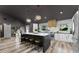 Open concept kitchen with a large island, seating, white cabinets, and stainless appliances at 1313 W Carissa Ct, Tampa, FL 33604