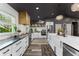 Bright kitchen with white cabinets, a large island, stainless steel appliances, and dark ceiling at 1313 W Carissa Ct, Tampa, FL 33604