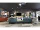 Open-concept living room with modern decor, a skylight, and gray color scheme at 1313 W Carissa Ct, Tampa, FL 33604
