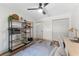 Bright office showcasing shelving units, overhead fan, and wood-look flooring at 1313 W Carissa Ct, Tampa, FL 33604