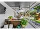 Inviting screened patio with comfortable seating, overhead fan, and decorative plants at 1313 W Carissa Ct, Tampa, FL 33604