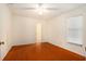Comfortable bedroom features wood floors, a window, and a doorway to another room at 13310 Golf Crest Cir, Tampa, FL 33618