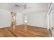 Spacious bedroom featuring hardwood floors, a ceiling fan, and large windows at 13310 Golf Crest Cir, Tampa, FL 33618