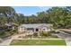 Charming single-story home featuring mature landscaping and a circular driveway for easy access at 13310 Golf Crest Cir, Tampa, FL 33618
