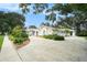Charming one-story home featuring a circular driveway and lush landscaping at 13310 Golf Crest Cir, Tampa, FL 33618