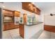 Modern kitchen featuring wood cabinets, stainless steel appliances, tile floors, and a breakfast bar at 13310 Golf Crest Cir, Tampa, FL 33618