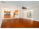 Open-concept living area seamlessly connects to the kitchen and tiled sunroom with a ceiling fan at 13310 Golf Crest Cir, Tampa, FL 33618