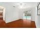 Bright living room features wood floors and sliding glass doors leading to the pool at 13310 Golf Crest Cir, Tampa, FL 33618