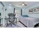 Functional bedroom with a desk, bed, and a window providing natural light, perfect for work or rest at 14105 Farmington Blvd, Tampa, FL 33625