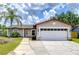 Charming single-story home with a well-manicured lawn, two car garage, and inviting front entrance at 14105 Farmington Blvd, Tampa, FL 33625