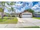 Charming single-story home with a two-car garage and well-maintained lawn at 14105 Farmington Blvd, Tampa, FL 33625