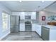Modern kitchen with stainless steel appliances, white cabinets, and stylish backsplash at 14105 Farmington Blvd, Tampa, FL 33625