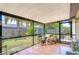 Enjoy this screened patio with tile flooring, outdoor seating, and views of the backyard and storage shed at 14105 Farmington Blvd, Tampa, FL 33625
