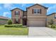 Charming two-story home featuring a well-maintained lawn and a two-car garage at 1613 Cabbage Key Dr, Ruskin, FL 33570