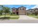 Beautiful home with a green lawn, inviting entryway, and attached two-car garage at 1613 Cabbage Key Dr, Ruskin, FL 33570