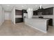 Bright kitchen with granite countertops, dark cabinets, tile floors, and stainless steel appliances at 1613 Cabbage Key Dr, Ruskin, FL 33570