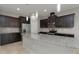 Modern kitchen with dark cabinets, granite countertops, stainless steel appliances, and pendant lighting at 1613 Cabbage Key Dr, Ruskin, FL 33570