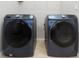 Modern laundry room featuring front-load Samsung washer and dryer units at 1613 Cabbage Key Dr, Ruskin, FL 33570