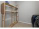 Functional laundry area with shelving and a glimpse of the washer and dryer at 1613 Cabbage Key Dr, Ruskin, FL 33570