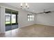Living room with tile floors, ceiling fan, and sliding glass doors to the patio at 1613 Cabbage Key Dr, Ruskin, FL 33570