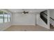 Open living room with tile floors, ceiling fan, and staircase at 1613 Cabbage Key Dr, Ruskin, FL 33570
