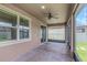 Spacious screened-in patio with brick flooring and a ceiling fan, perfect for outdoor living at 1613 Cabbage Key Dr, Ruskin, FL 33570