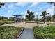 Community playground featuring swings and a covered play structure for residents to enjoy at 1613 Cabbage Key Dr, Ruskin, FL 33570