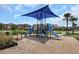Community playground with slides and covered play area, providing a fun recreational space at 1613 Cabbage Key Dr, Ruskin, FL 33570