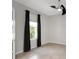 Bright, neutral room featuring a window, ceiling fan, and tiled floor at 1613 Cabbage Key Dr, Ruskin, FL 33570