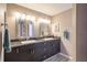 Bathroom with double sinks, dark wood cabinets, and granite countertop at 17735 Oak Bridge St, Tampa, FL 33647