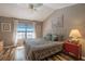 Bedroom with vaulted ceiling, ceiling fan, wood floors and large window at 17735 Oak Bridge St, Tampa, FL 33647