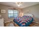 Bedroom with natural light, a ceiling fan, and wood-look flooring at 17735 Oak Bridge St, Tampa, FL 33647