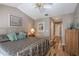 Bedroom with ceiling fan, wood floors, and access to hallway at 17735 Oak Bridge St, Tampa, FL 33647