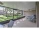 Screened lanai perfect for relaxing with comfortable seating and a ceiling fan at 17735 Oak Bridge St, Tampa, FL 33647