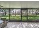 Screened in lanai featuring view of green lawn and houses at 17735 Oak Bridge St, Tampa, FL 33647