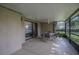 Covered screened-in lanai with outdoor seating and view to indoor living area at 17735 Oak Bridge St, Tampa, FL 33647