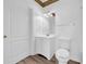Bright bathroom featuring a white vanity, toilet, and decorative mirror at 17996 Villa Creek Dr # 17996, Tampa, FL 33647