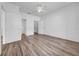 Spacious bedroom with wood-look flooring, a ceiling fan, and ensuite bathroom and walk-in closet at 17996 Villa Creek Dr # 17996, Tampa, FL 33647